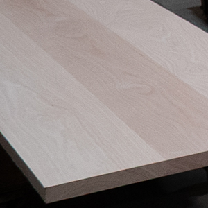A smooth glued-up maple panel with a cleanly milled edge