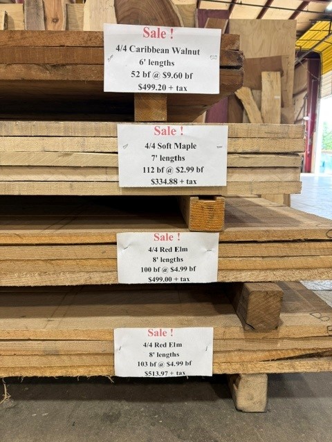 Sale tags on the four hardwood bundles: Caribbean Walnut, Soft Maple and two Red Elm bundles